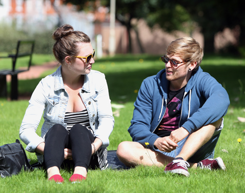 Two students sitting on grass. Original file name: denton41.jpg