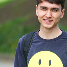 male smiling with smiley face jumper 