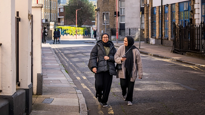 Two students walking down a street