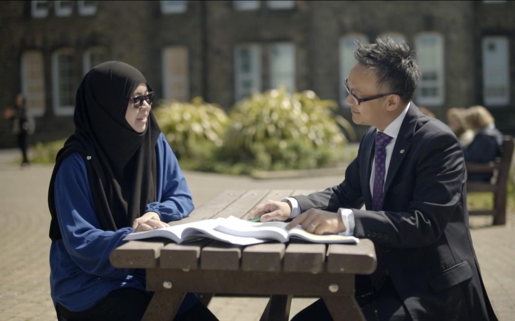 A student chats to a teacher.