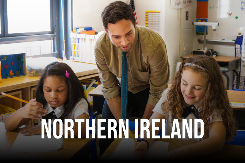 Northern Ireland text with a male teacher and children working