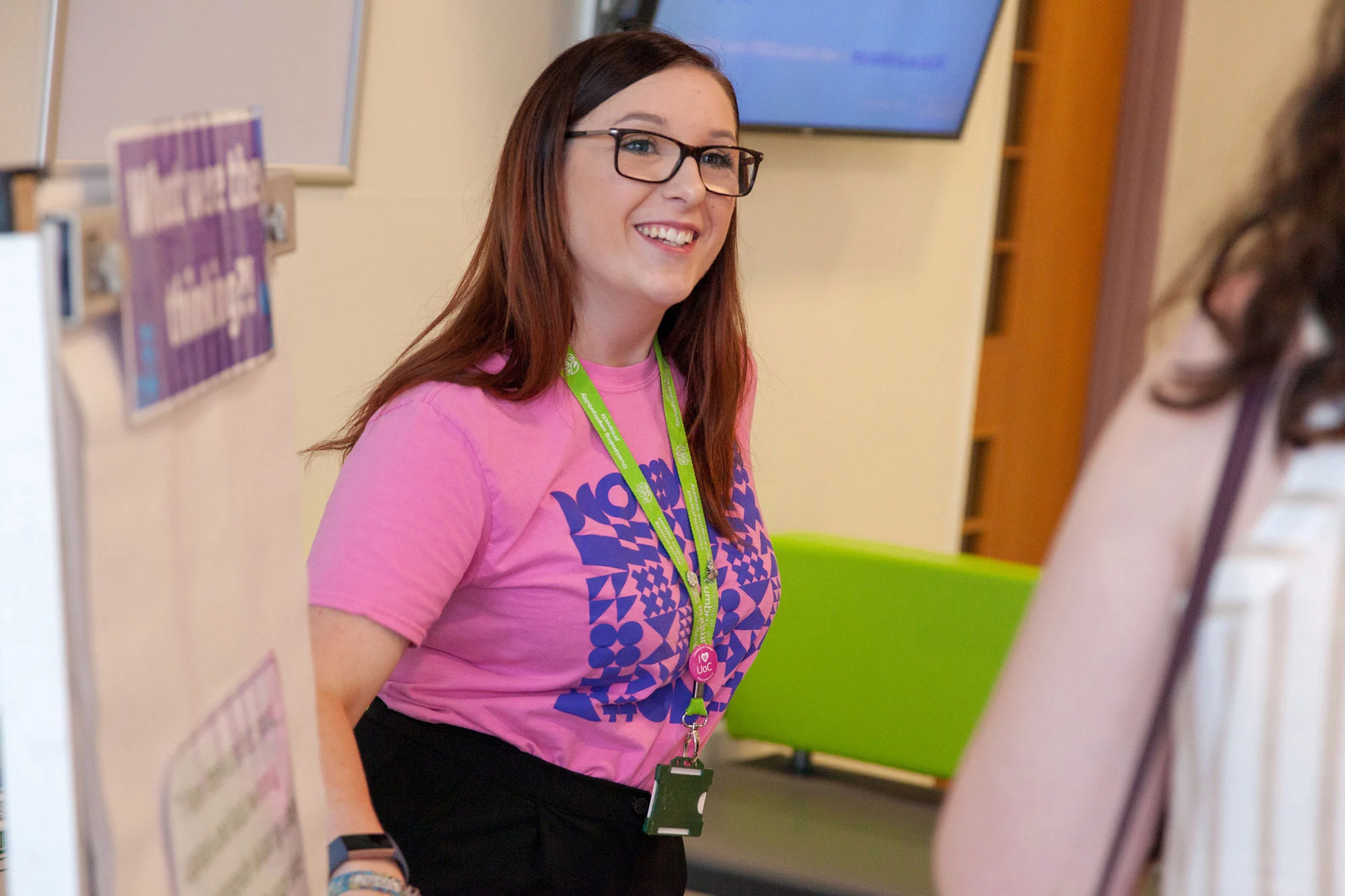 A University of Cumbria student helps people at an open day.