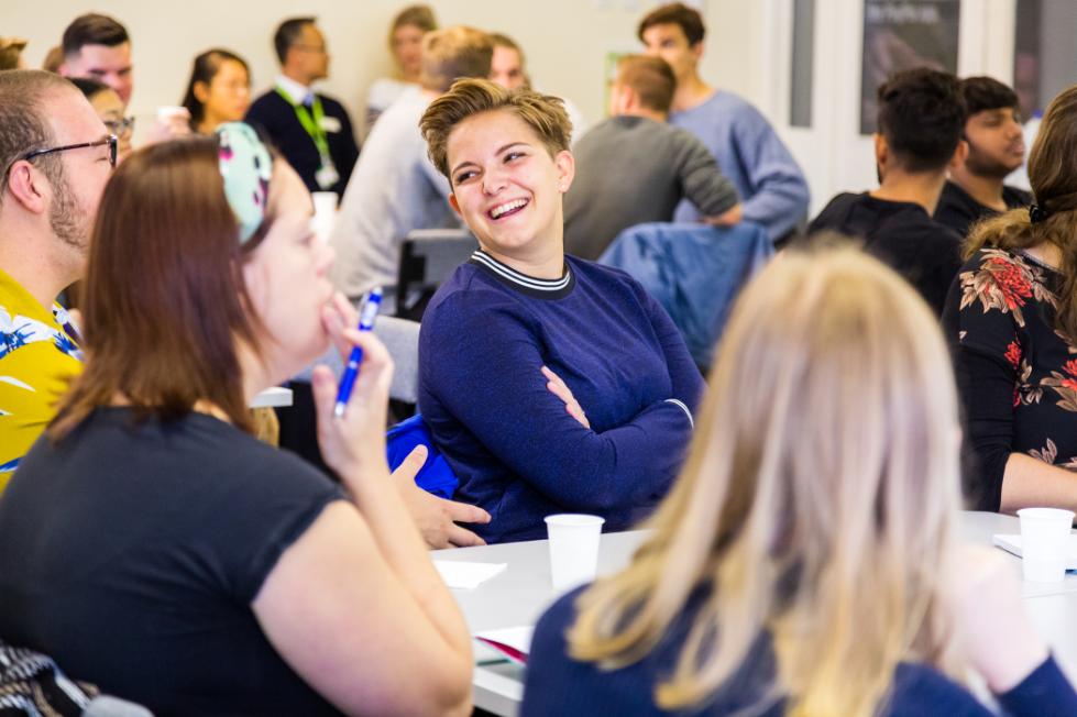 A student smiles at their classmates.